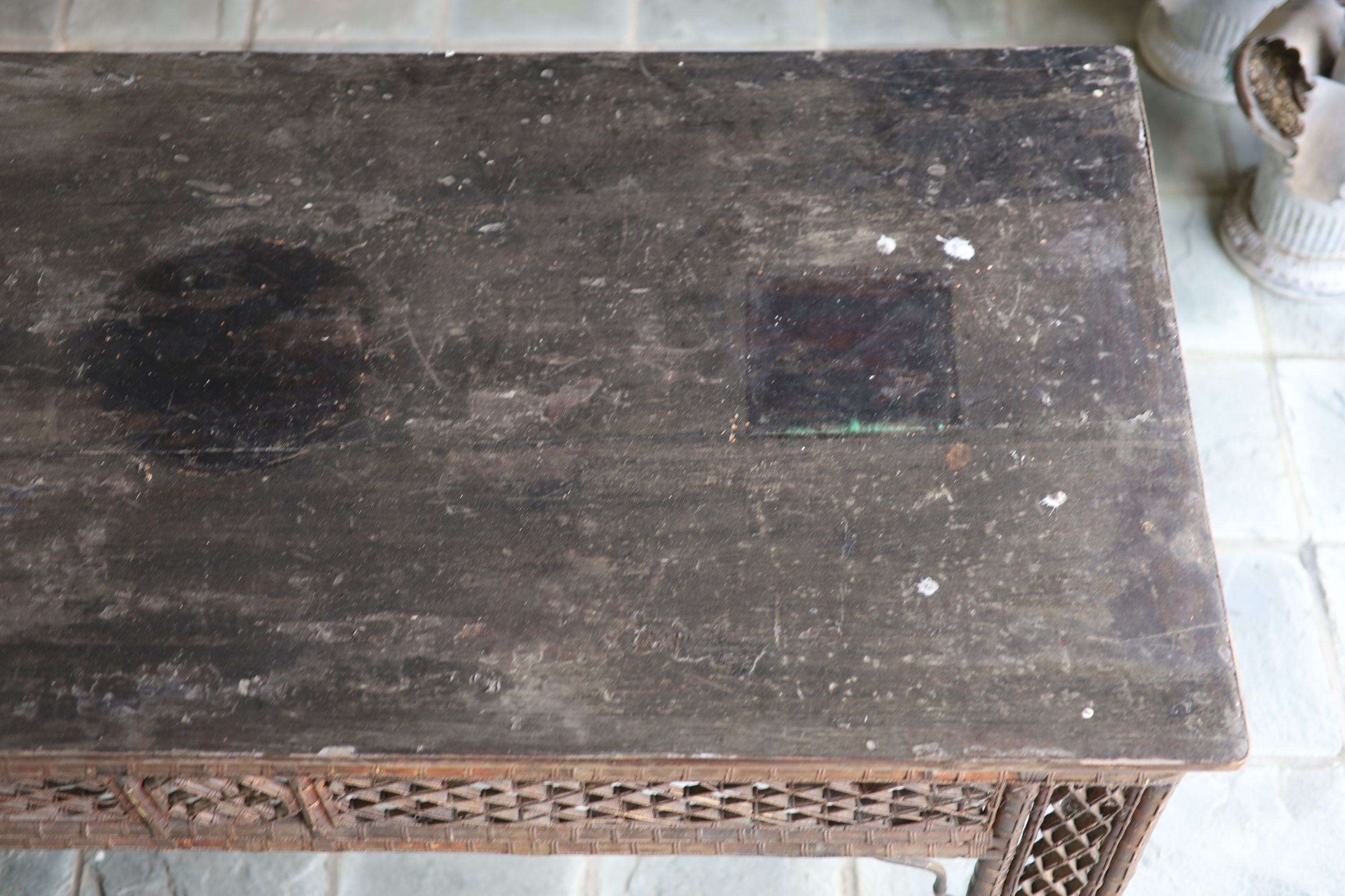 A bamboo and rattan centre table, with black lacquered top, width 166cm depth 76cm height 86cm